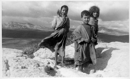 children with mountains and valley in background